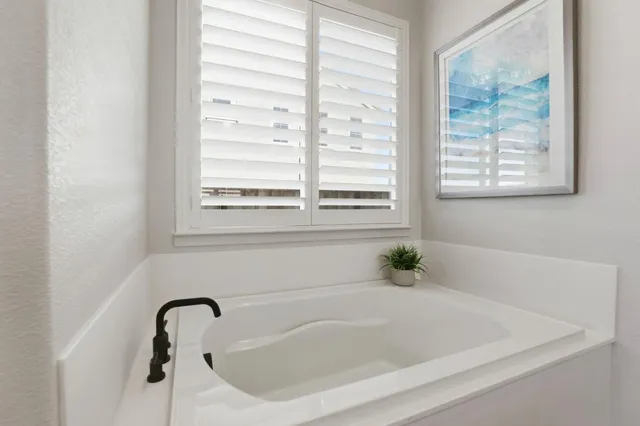 a white bath tub sitting next to a window
