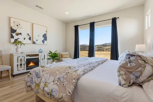 a bedroom with a bed and a fireplace