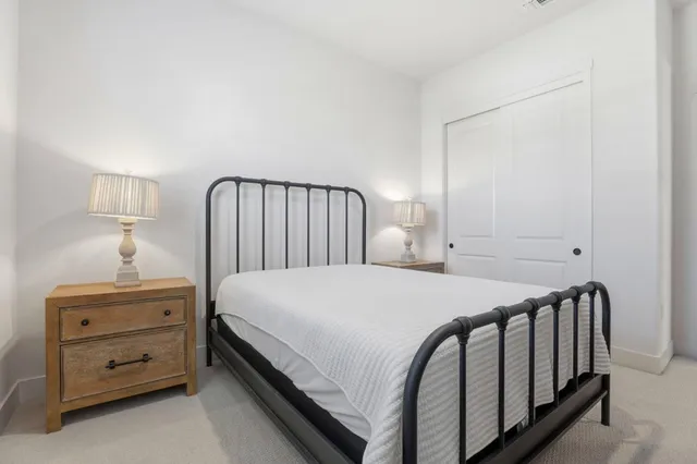 a bedroom with a bed and a night stand