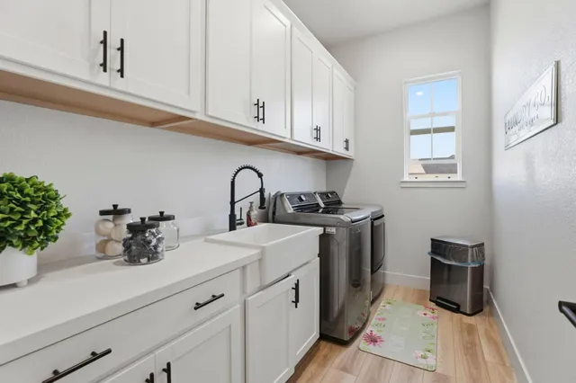 a kitchen with stainless steel appliances white cabinets and a sink