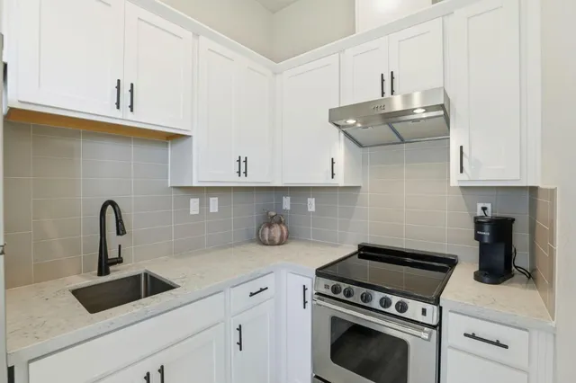 a kitchen with cabinets a sink and appliances