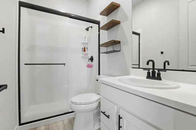 a bathroom with a sink toilet and shower
