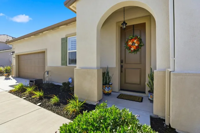 a front view of a house with a garden