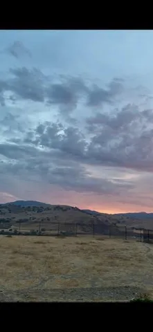 a view of mountain with wooden fence