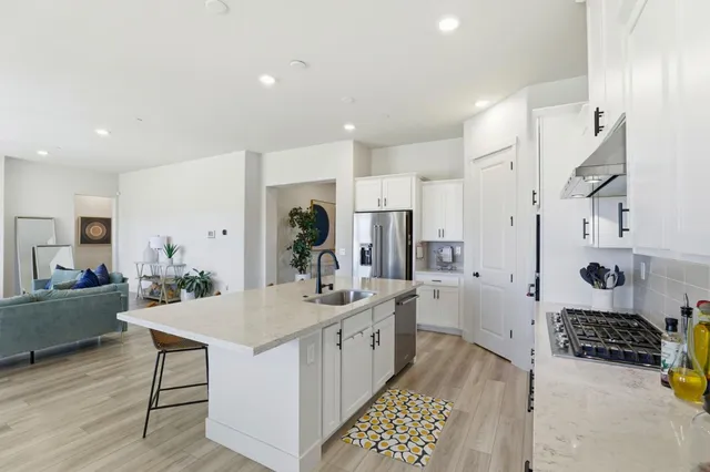 a kitchen with a sink stove and refrigerator