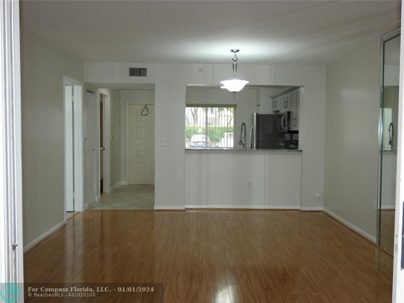 9525 Weldon Circle, Unit H110 Tamarac, FL 33321 - Photo 12 of 20 an empty room with wooden floor and windows