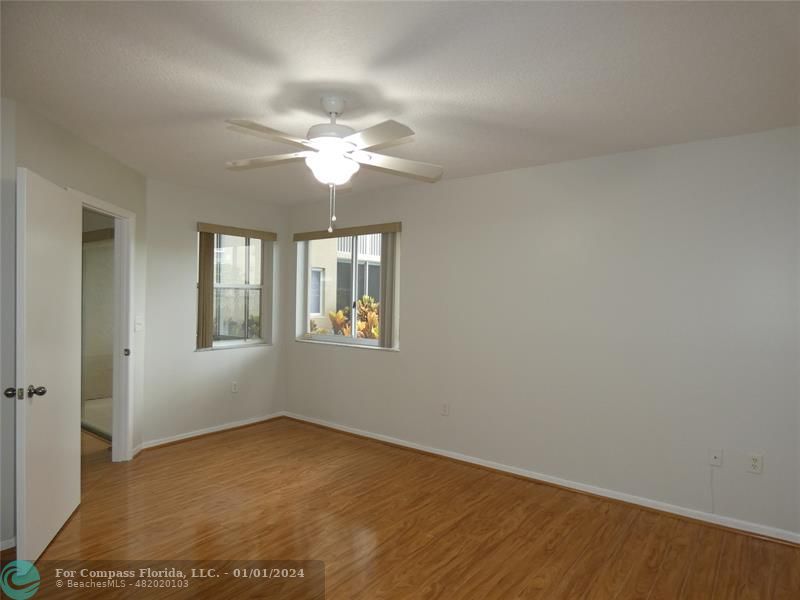 9525 Weldon Circle, Unit H110 Tamarac, FL 33321 - Photo 14 of 20 an empty room with windows and fan