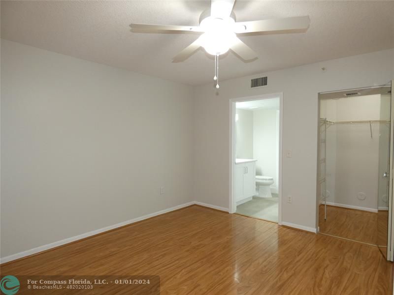9525 Weldon Circle, Unit H110 Tamarac, FL 33321 - Photo 15 of 20 wooden floor in an empty room with a window