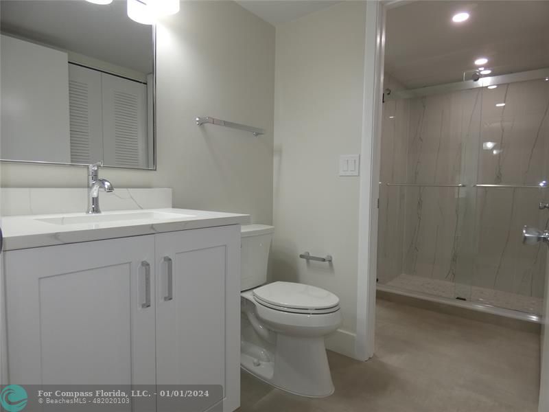 9525 Weldon Circle, Unit H110 Tamarac, FL 33321 - Photo 5 of 20 a bathroom with a sink a toilet and shower