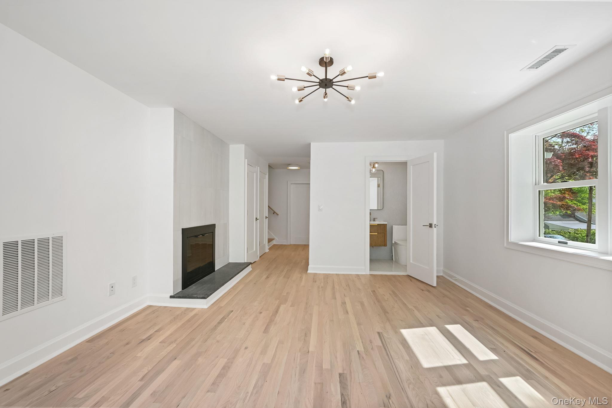 24 Country Road Mamaroneck, NY 10543 - Photo 11 of 37 a view of empty room with wooden floor and fan