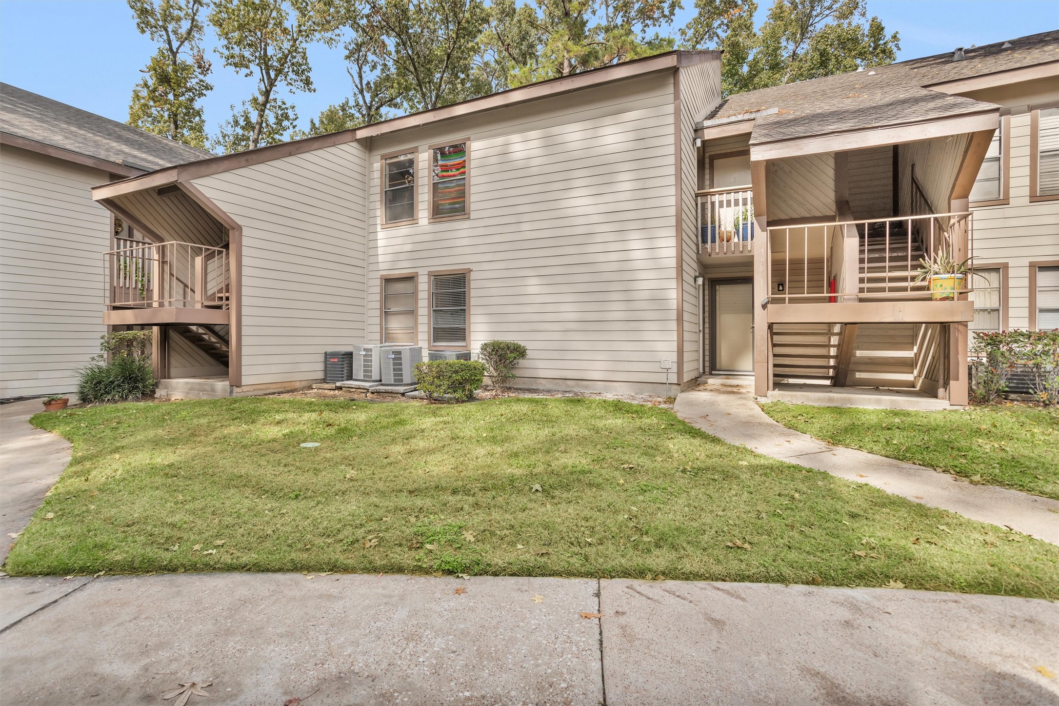 12900 Walden Road, Unit 513 Montgomery, TX 77356 - Photo 2 of 20 a view of a house with a yard and a street