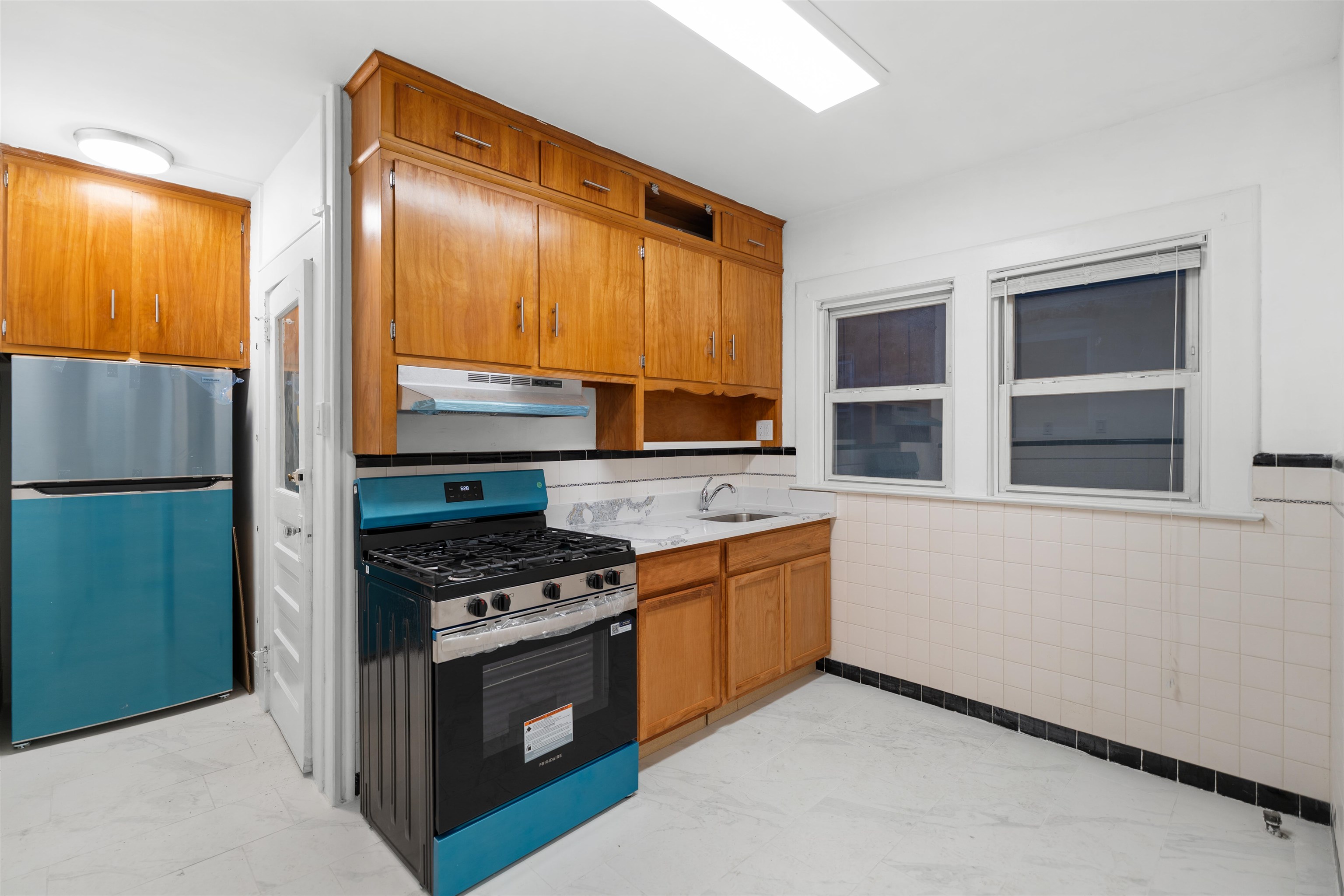 616 Chestnut Street, Unit 2 Kearny, NJ 07032 - Photo 10 of 21 a kitchen with stainless steel appliances granite countertop a stove a sink and a refrigerator