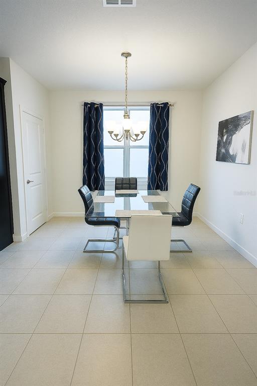 181 Trinity Ridge Circle Davenport, FL 33897 - Photo 3 of 10 a dining room with table and chairs