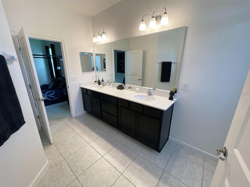 181 Trinity Ridge Circle Davenport, FL 33897 - Photo 5 of 10 a bathroom with a sink vanity and mirror