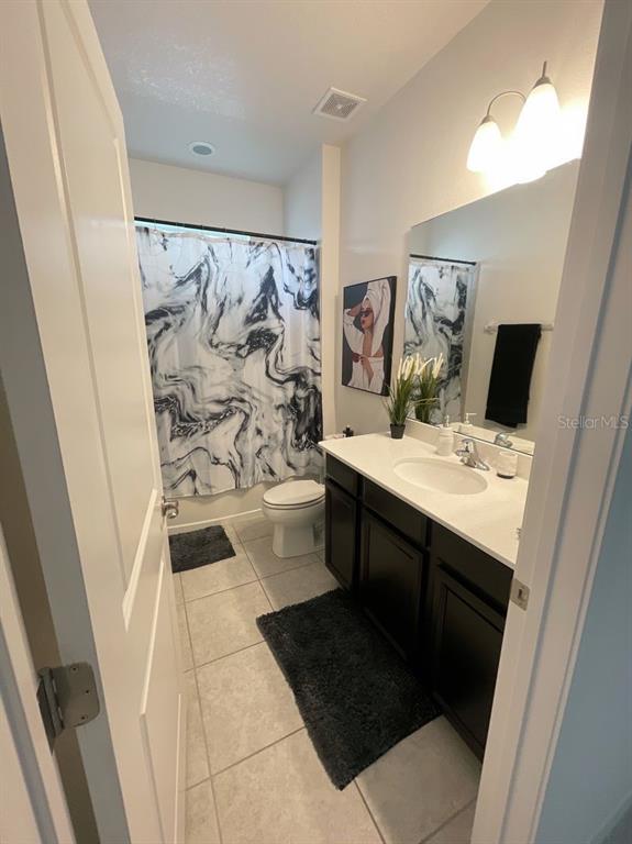 181 Trinity Ridge Circle Davenport, FL 33897 - Photo 7 of 10 a bathroom with a sink and a mirror