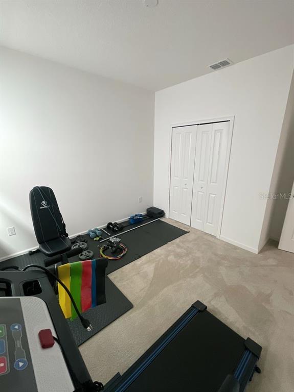 181 Trinity Ridge Circle Davenport, FL 33897 - Photo 8 of 10 a bedroom with a bed and a window