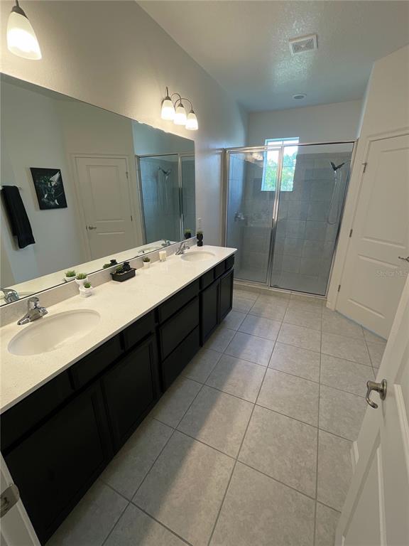 181 Trinity Ridge Circle Davenport, FL 33897 - Photo 9 of 10 a bathroom with a sink vanity granite tub shower and mirror