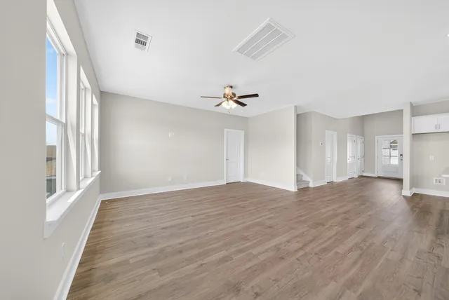 a bathroom with a granite countertop sink a toilet and a large mirror