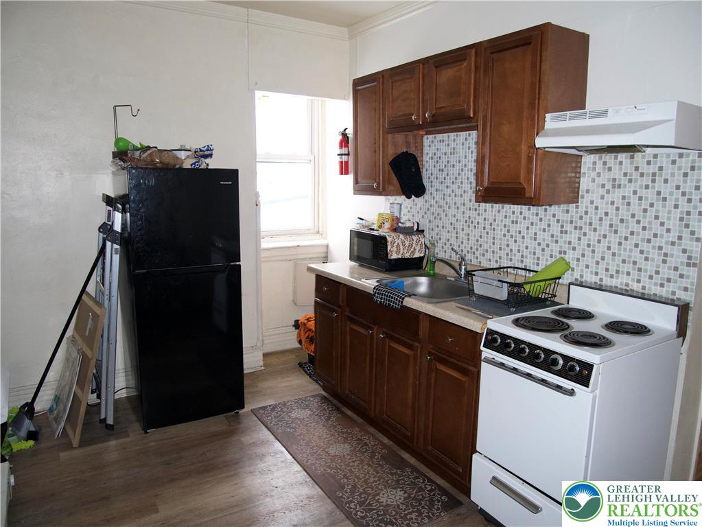518 Tilghman Street, Unit 3 Allentown, PA 18102 - Photo 4 of 14 a kitchen with a sink and a refrigerator