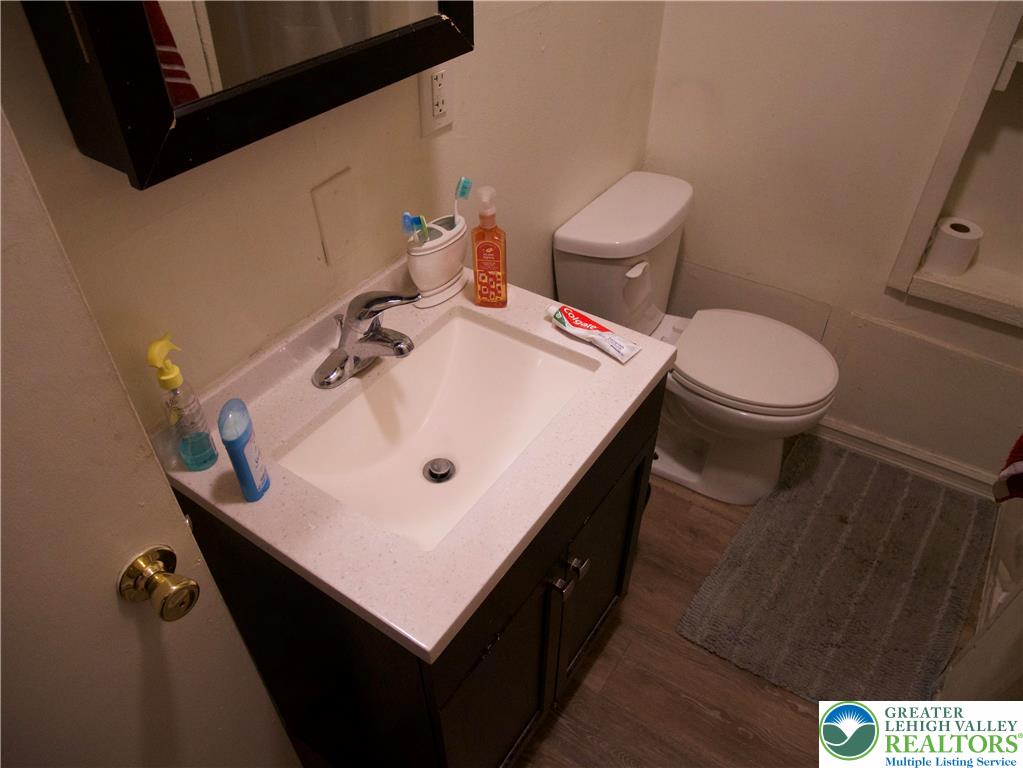518 Tilghman Street, Unit 3 Allentown, PA 18102 - Photo 9 of 14 a bathroom with a sink a toilet and a mirror