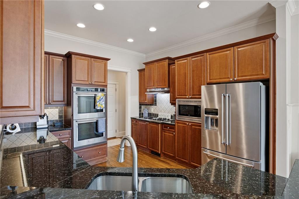 237 Highcrest Drive Acworth, GA 30101 - Photo 25 of 57 a kitchen with granite countertop a refrigerator stove and cabinets