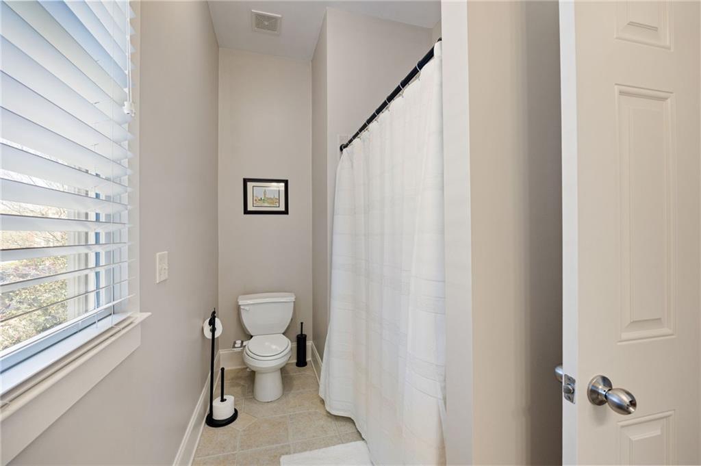 237 Highcrest Drive Acworth, GA 30101 - Photo 34 of 57 a bathroom with a toilet a sink and a window