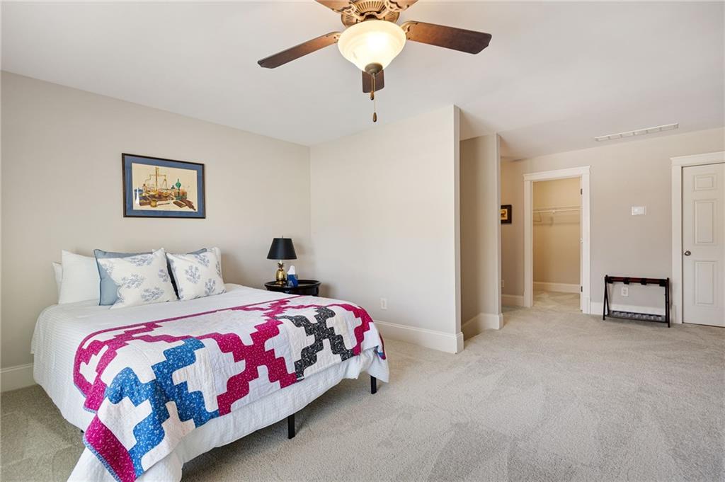 237 Highcrest Drive Acworth, GA 30101 - Photo 41 of 57 a bedroom with a bed and a chandelier