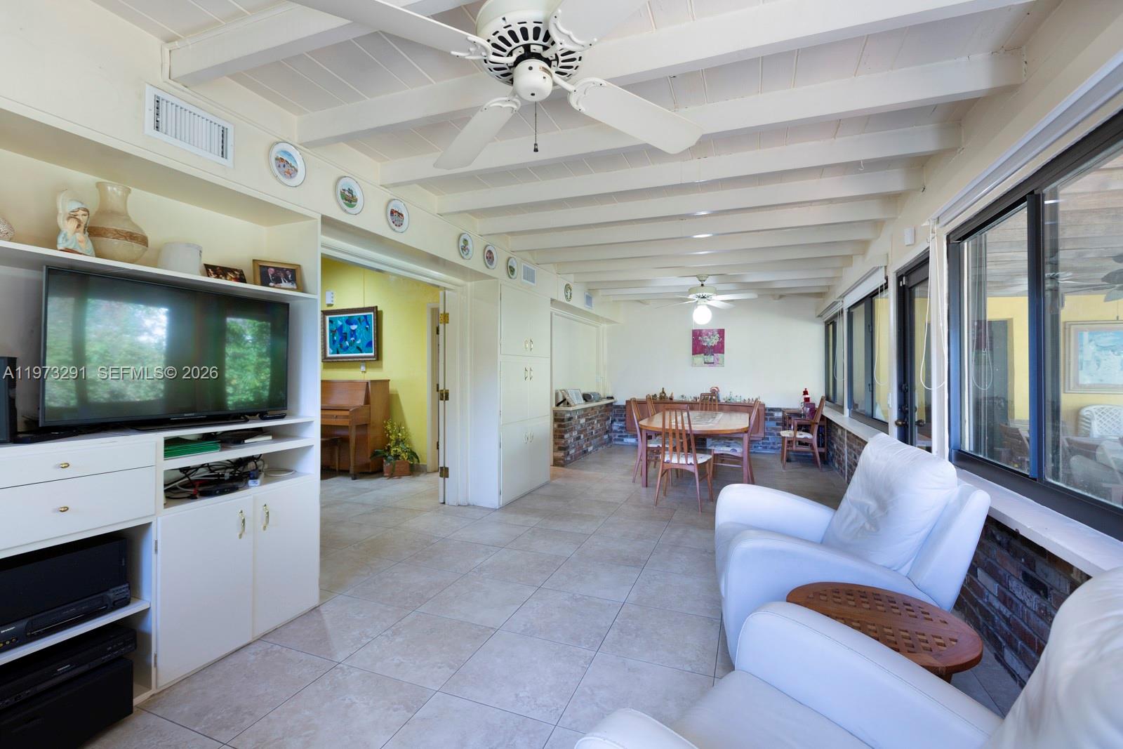 3721 Southwest 58th Avenue Miami, FL 33155 - Photo 11 of 23 a living room with furniture and a flat screen tv