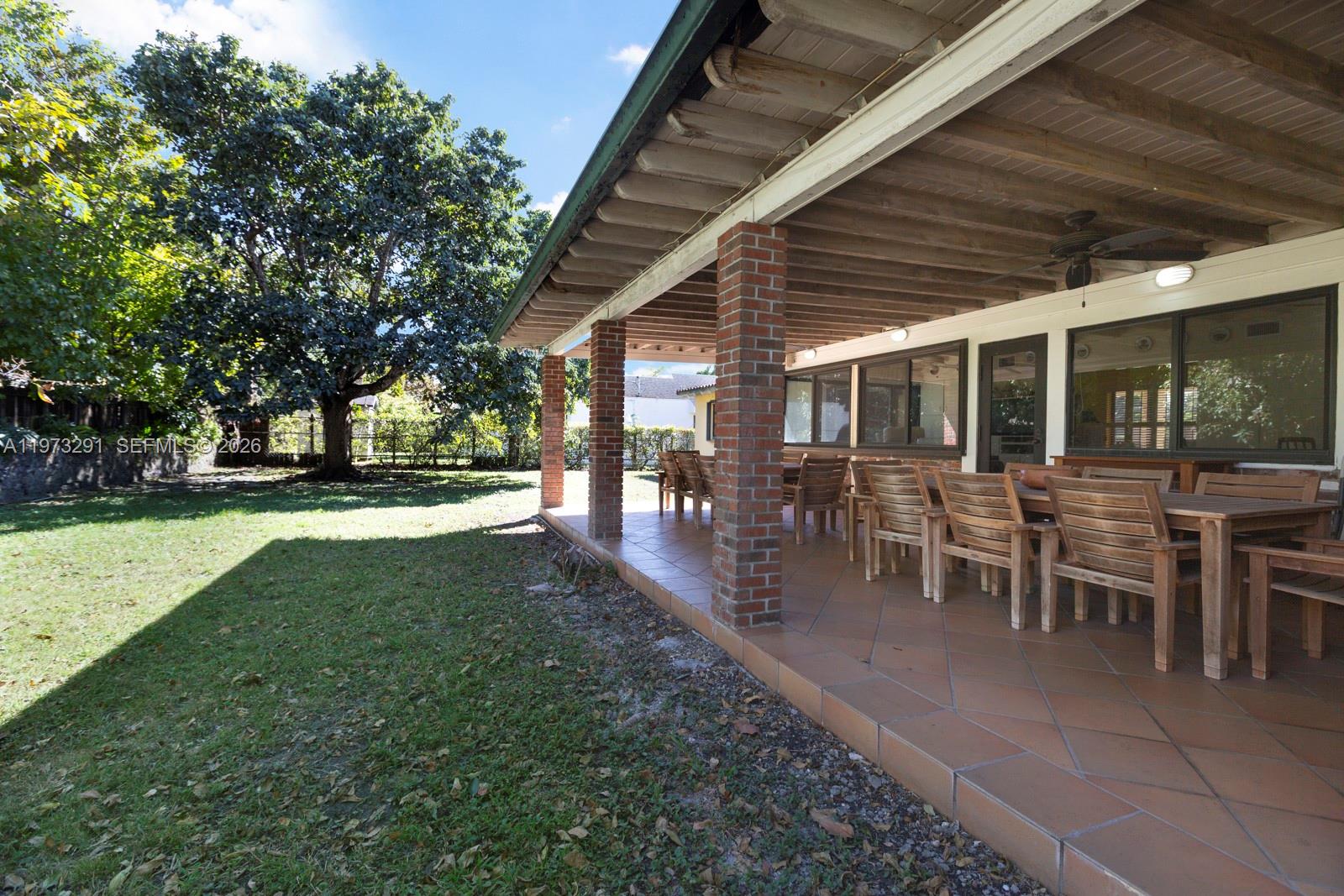 3721 Southwest 58th Avenue Miami, FL 33155 - Photo 14 of 23 a view of a backyard with table and chairs with a patio