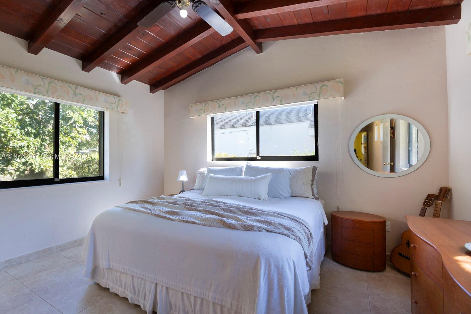 3721 Southwest 58th Avenue Miami, FL 33155 - Photo 16 of 23 a bedroom with a large bed and a large window