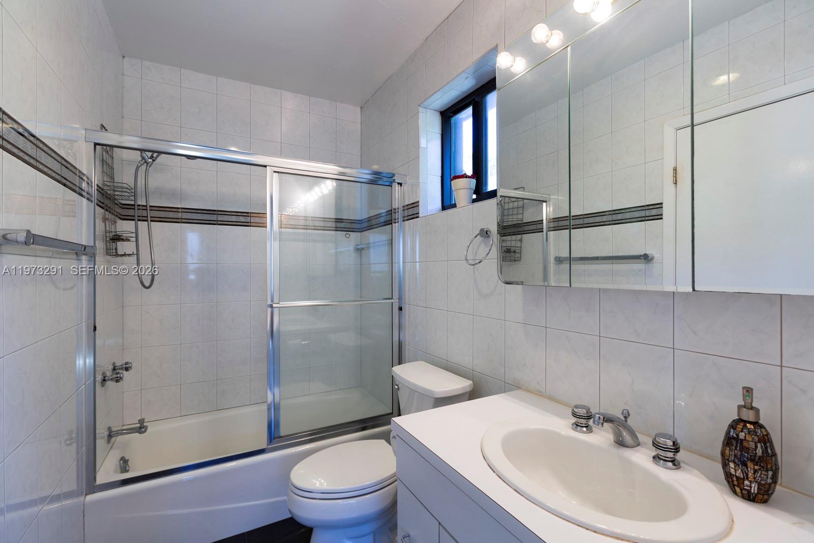 3721 Southwest 58th Avenue Miami, FL 33155 - Photo 17 of 23 a bathroom with a sink toilet and shower