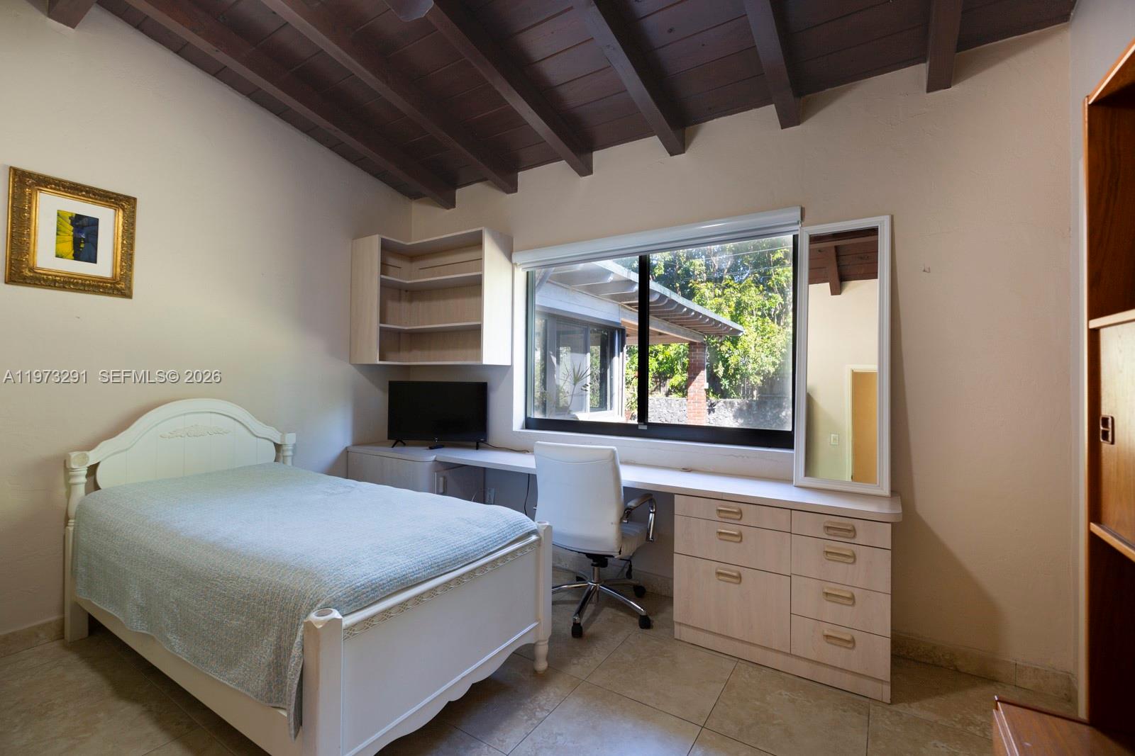 3721 Southwest 58th Avenue Miami, FL 33155 - Photo 18 of 23 a bedroom with a bed and a window