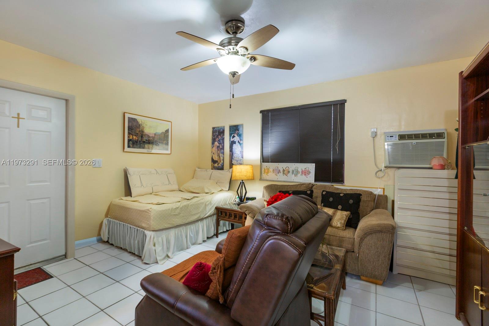 3721 Southwest 58th Avenue Miami, FL 33155 - Photo 20 of 23 a living room with furniture and a flat screen tv