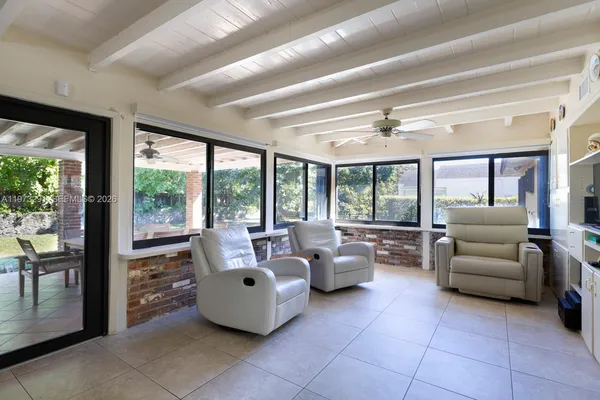 a living room with furniture and large windows
