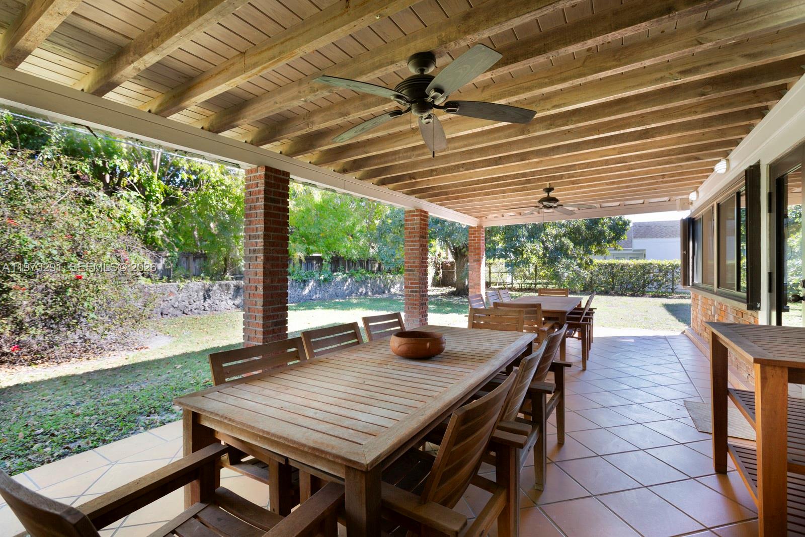 3721 Southwest 58th Avenue Miami, FL 33155 - Photo 5 of 23 a view of a patio with a table and chairs