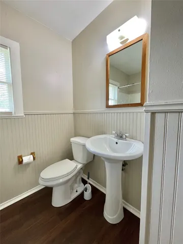 a bathroom with a toilet sink and mirror