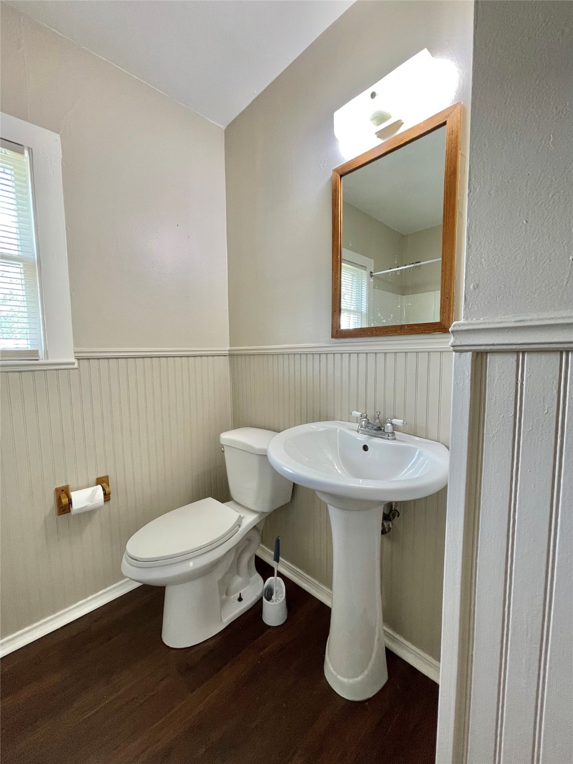 813 Nursery Street Clute, TX 77531 - Photo 11 of 24 a bathroom with a toilet sink and mirror