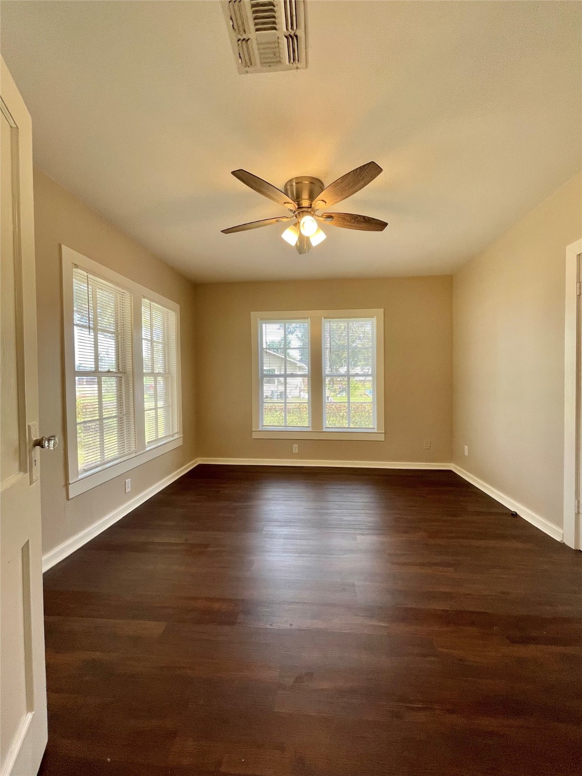 813 Nursery Street Clute, TX 77531 - Photo 15 of 24 an empty room with wooden floor and windows