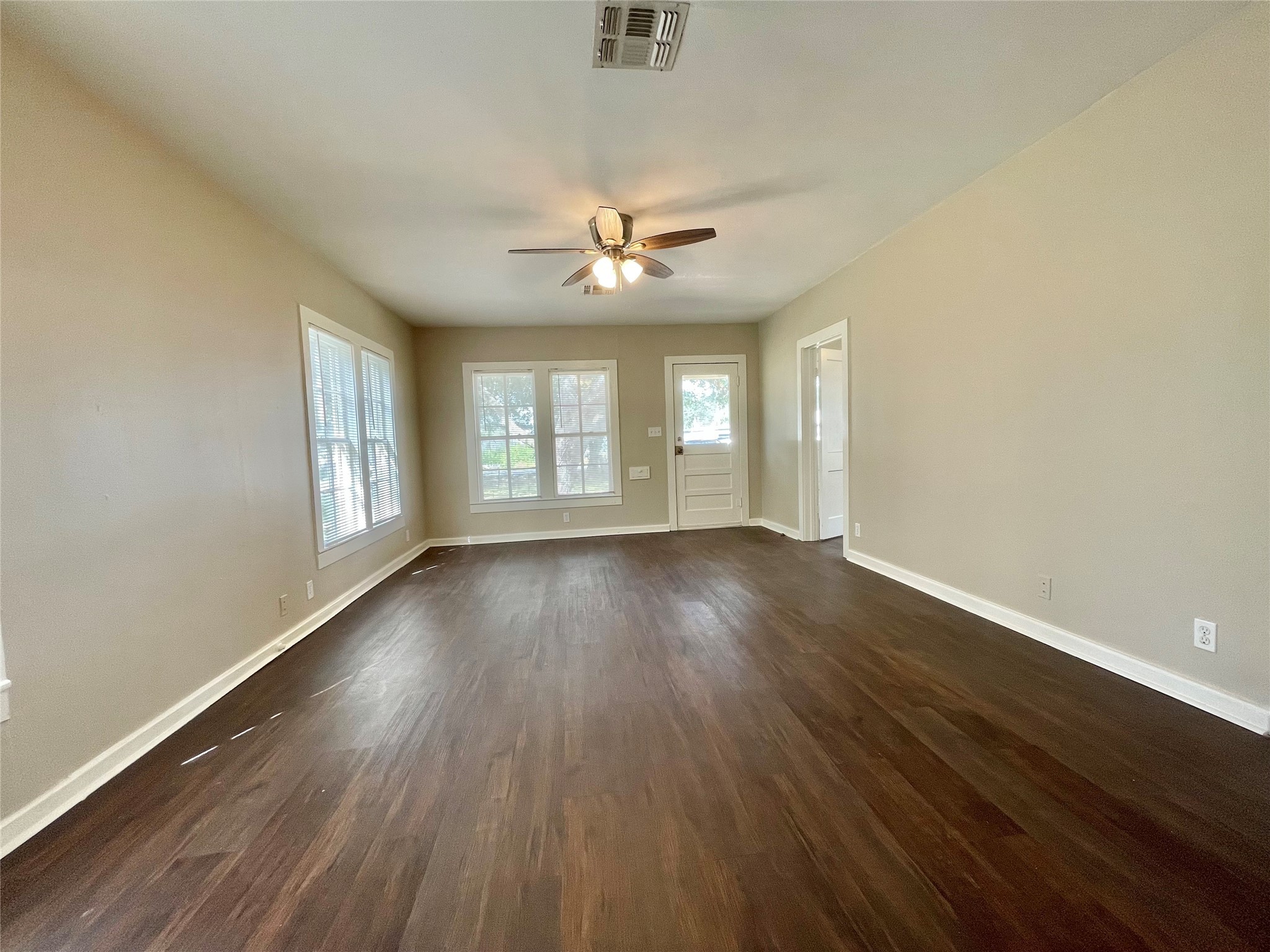 813 Nursery Street Clute, TX 77531 - Photo 16 of 24 an empty room with wooden floor and windows