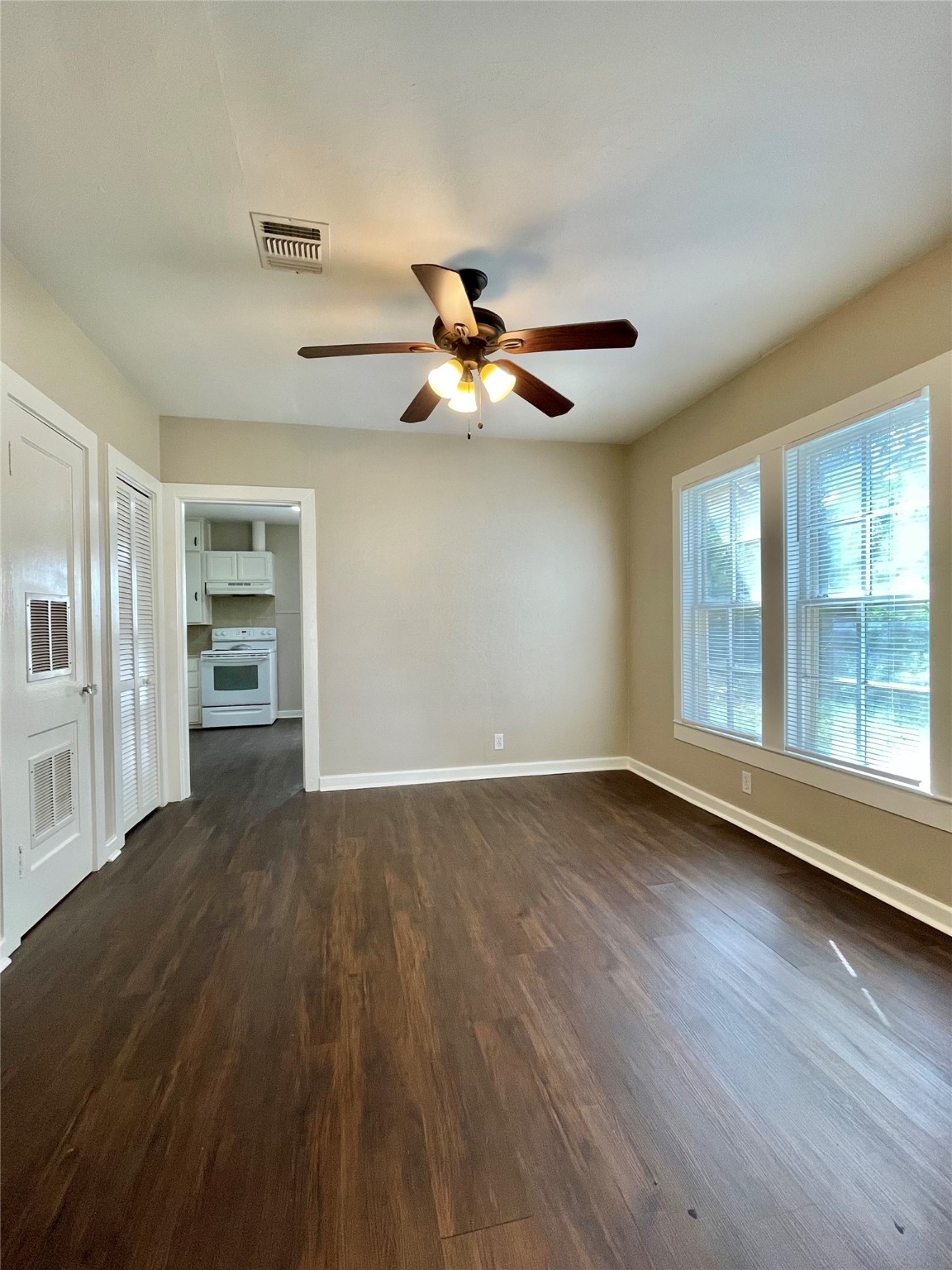 813 Nursery Street Clute, TX 77531 - Photo 18 of 24 a view of an empty room with a window and wooden floor