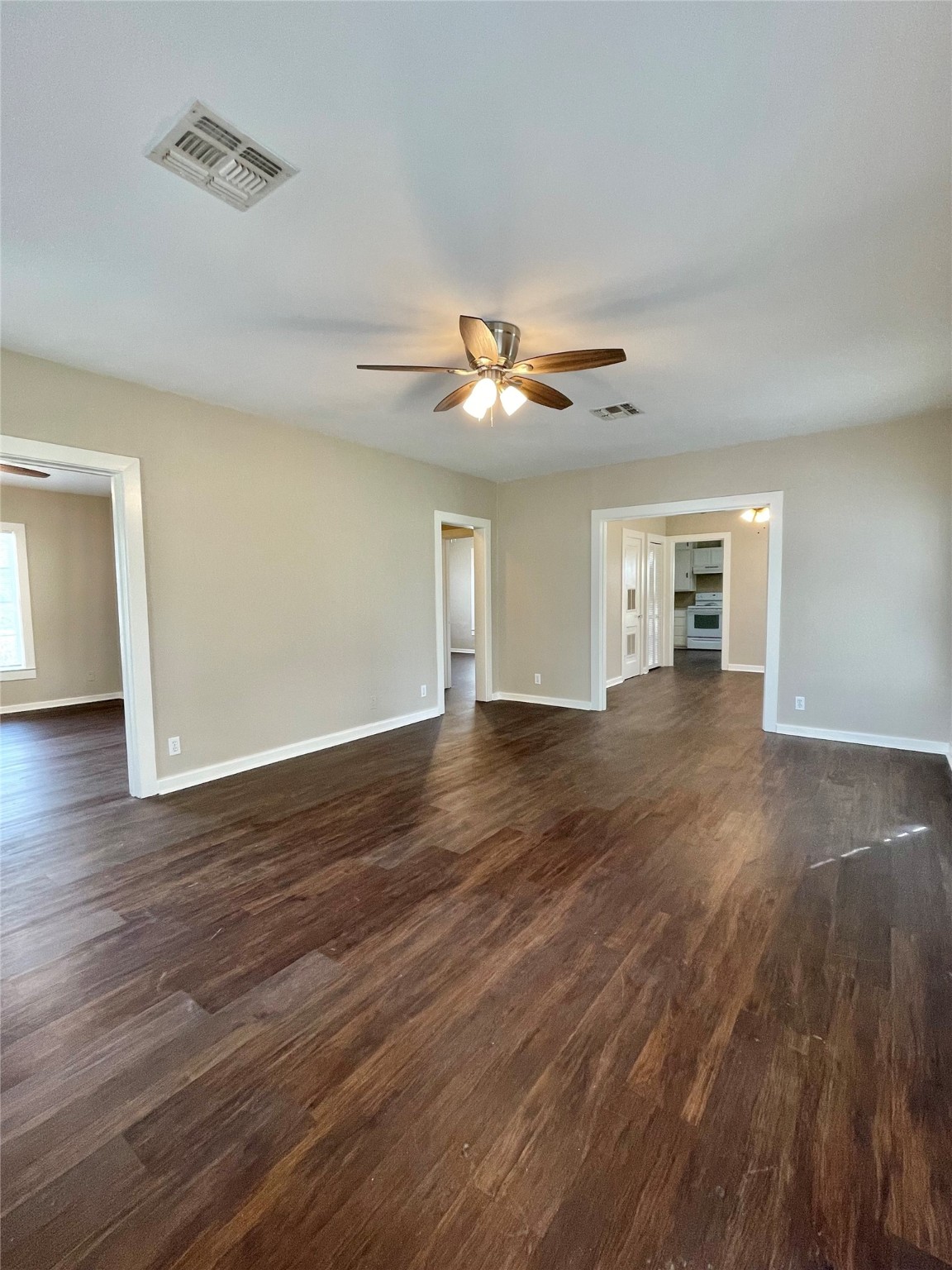 813 Nursery Street Clute, TX 77531 - Photo 19 of 24 a view of a livingroom with wooden floor and a ceiling fan
