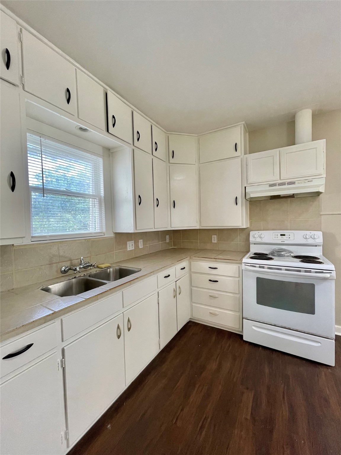 813 Nursery Street Clute, TX 77531 - Photo 4 of 24 a kitchen with granite countertop white cabinets and white appliances