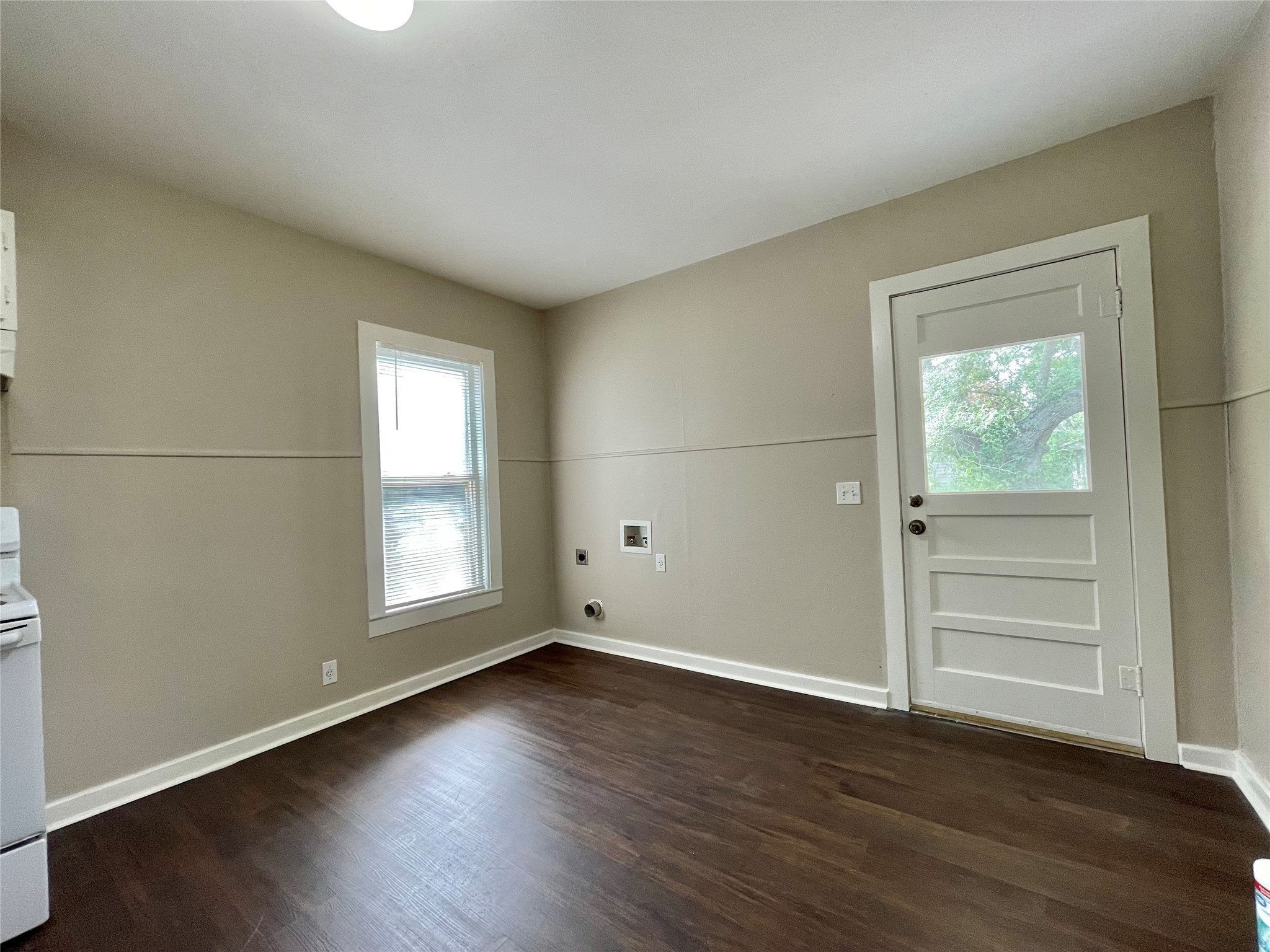 813 Nursery Street Clute, TX 77531 - Photo 6 of 24 an empty room with wooden floor and windows