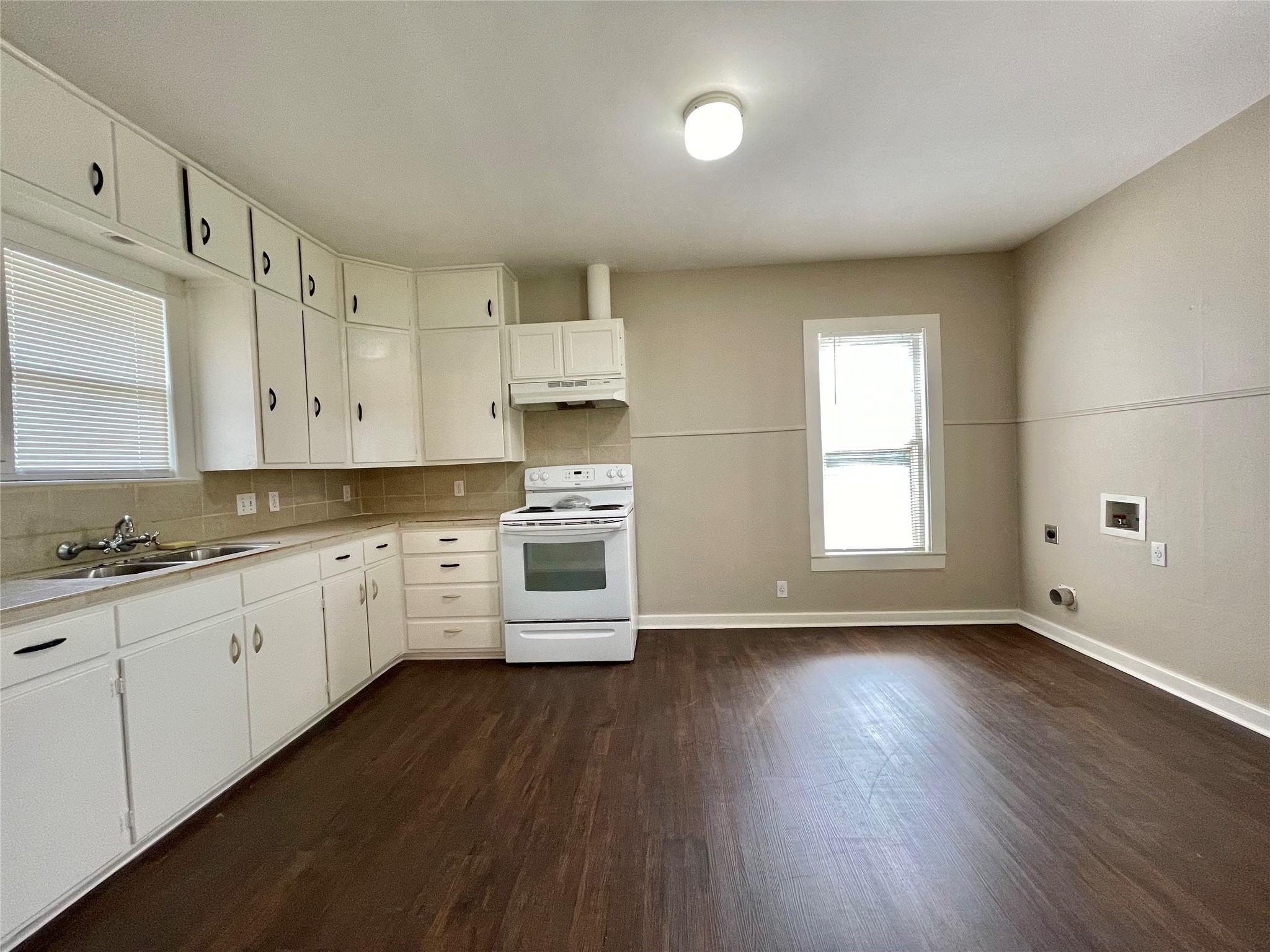 813 Nursery Street Clute, TX 77531 - Photo 7 of 24 a kitchen with granite countertop white cabinets and wooden floor