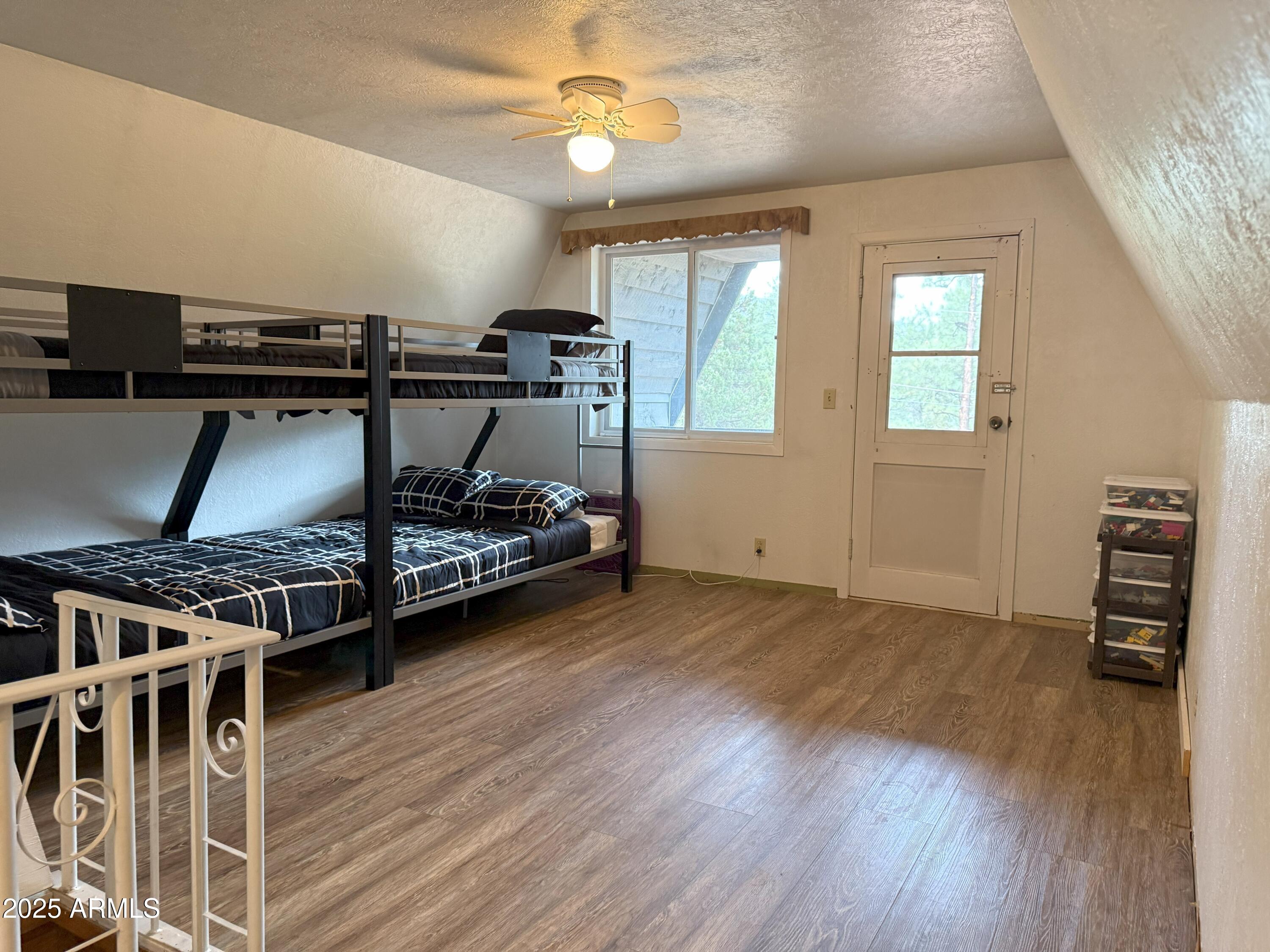 3868 Bloody Basin Road Pine, AZ 85544 - Photo 12 of 17 a bedroom with furniture and a wooden floor