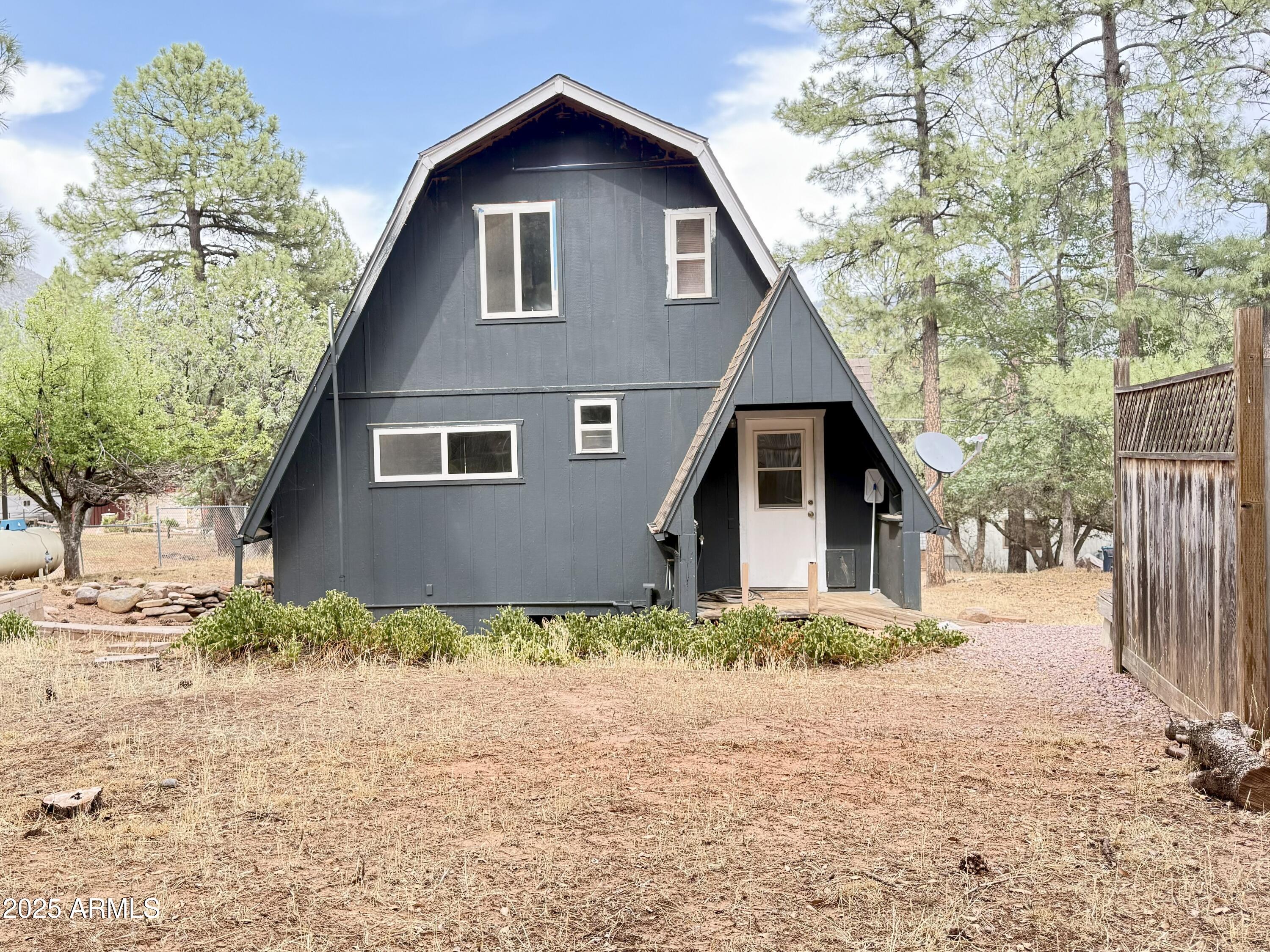 3868 Bloody Basin Road Pine, AZ 85544 - Photo 14 of 17 a front view of a house with a yard