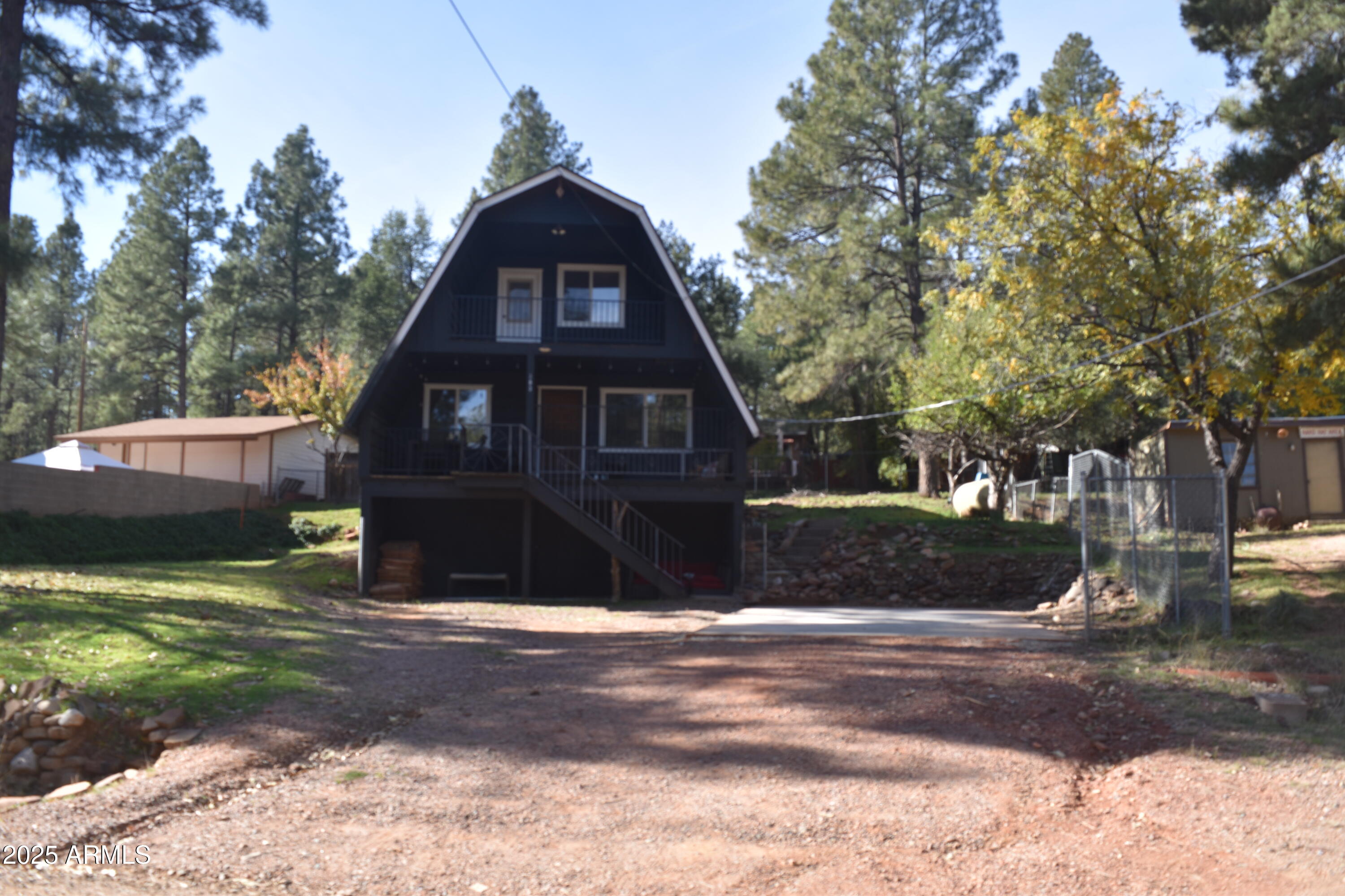 3868 Bloody Basin Road Pine, AZ 85544 - Photo 15 of 17 a front view of a house with a yard