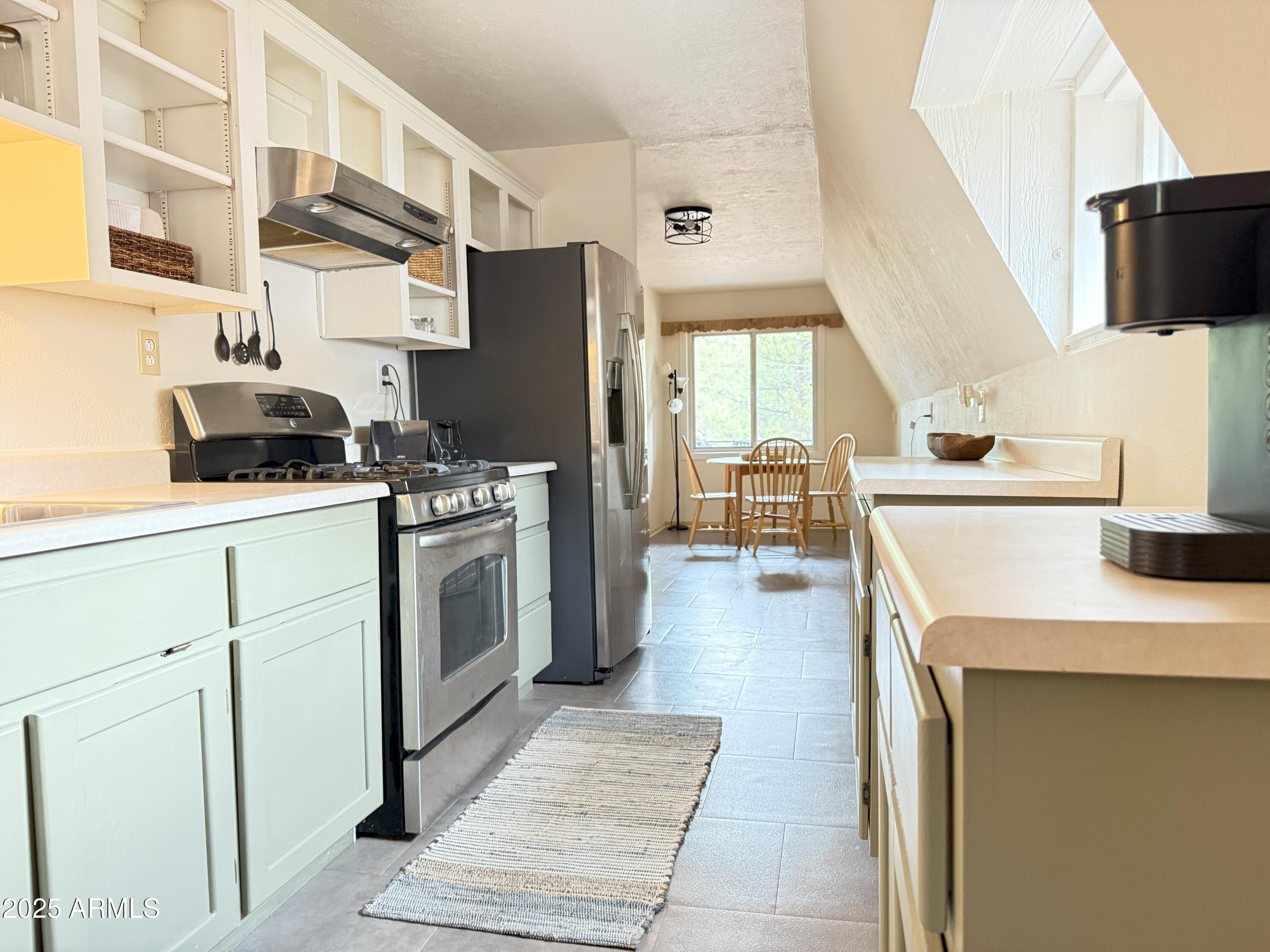 3868 Bloody Basin Road Pine, AZ 85544 - Photo 7 of 17 a kitchen with a stove a sink and a refrigerator