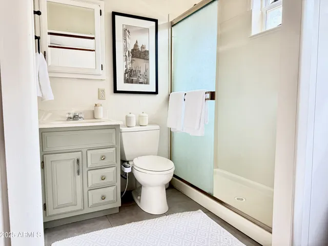 a bathroom with a toilet sink and a mirror
