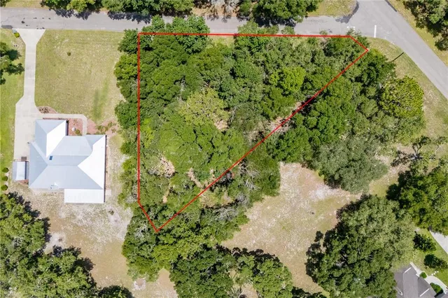 an aerial view of a house with a yard and garden